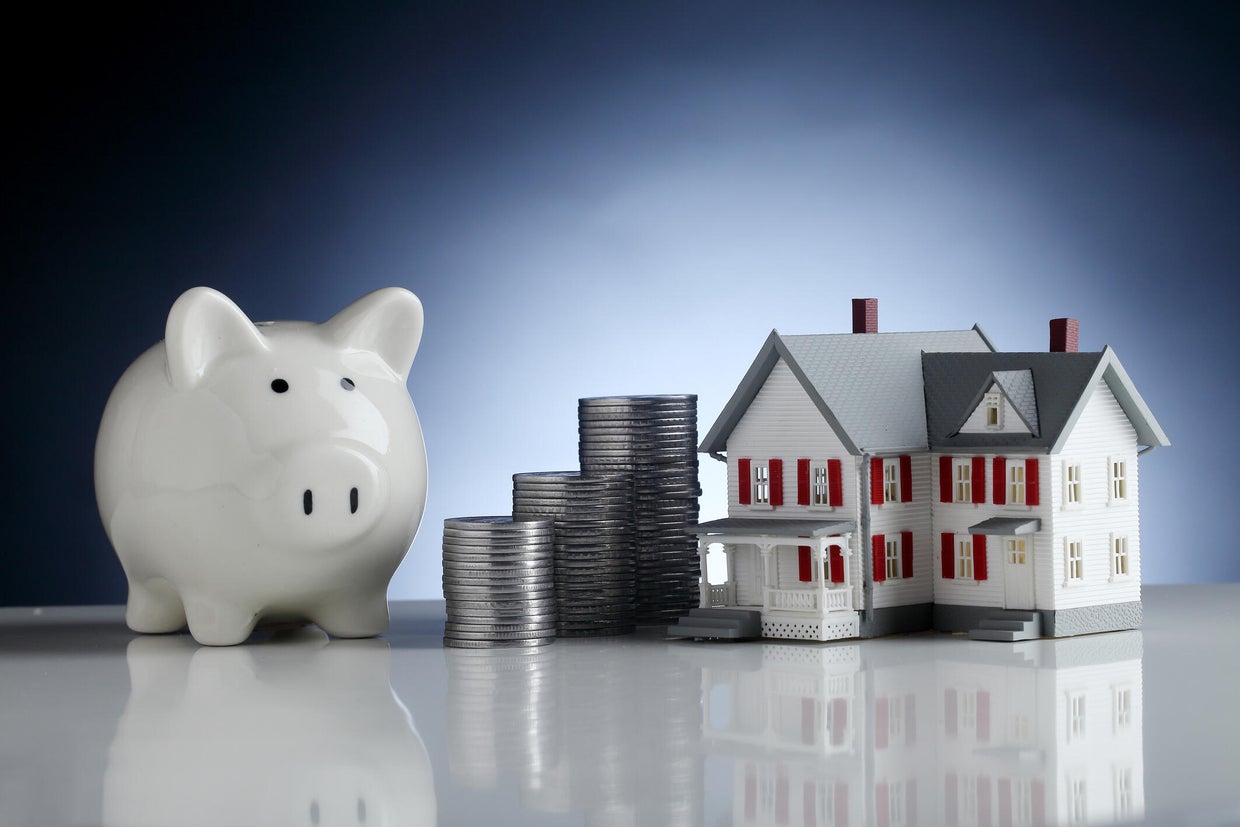 Piggy bank,model house and stack of coins-Concept of money saving