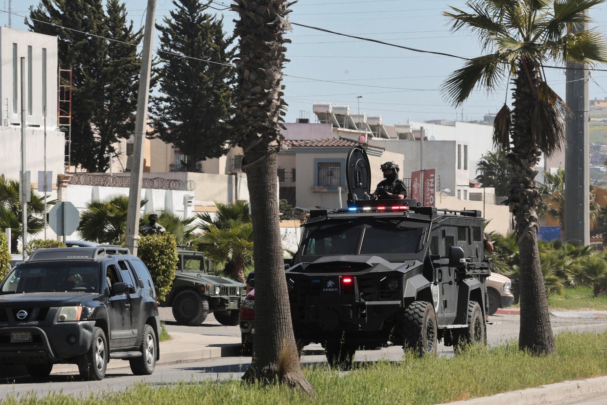 Security forces operate near a crime scene where an American citizen shot and killed a Mexican police officer in Tijuana
