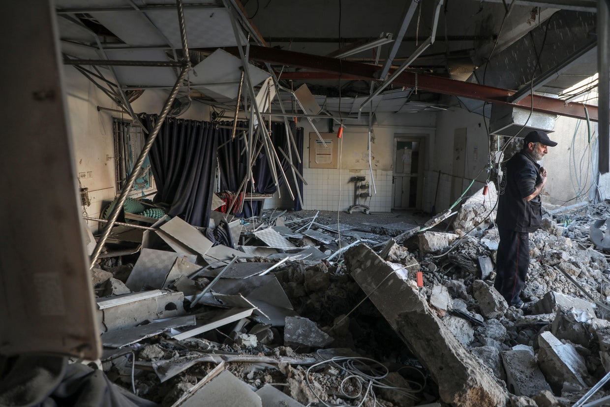 A Palestinian surveys the damage to a building inside the Al-Ahli Arab Hospital caused by an Israeli airstrike, in Gaza City