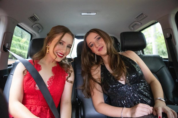 Graduates in the car going to their graduation party 