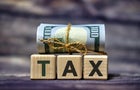Tax concept with dollars on a wooden background 