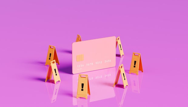 Caution Ahead - Oversized Credit Card with Surrounding Warning Signs 