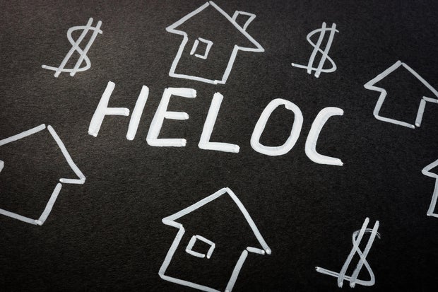HELOC home equity line of credit loan and homes on the black sheet. 