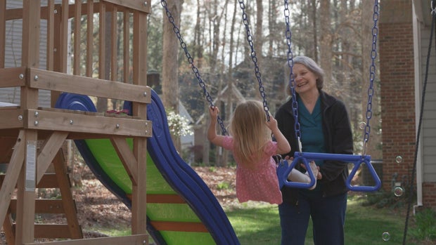 Beth Humphrey pushing her granddaughter on a swing