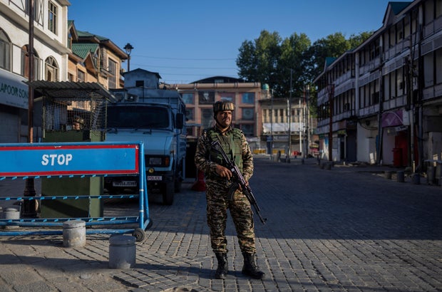 A security force staff of India is stored in a street in Srinagar