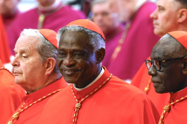 Ghana's Cardinal Peter Turkson respects the body of Pope Francis, located on April 23, 2025, in St. Peter's Basilica in the Vatican. 