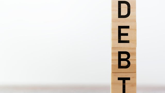 Debt written on wooden cubes with copy space 