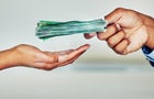 Paper money, payment or loan cash from a finance manager, banking employee or boss. Hand holding bank notes for financial investment profit, wealth growth for investing, retirement and budget 