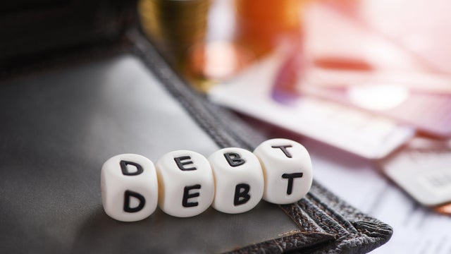Debt credit card and money coin stack Increased liabilities from exemption debt consolidation,Romania 