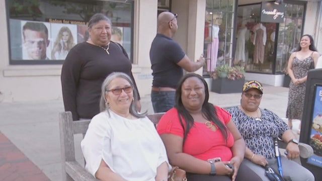 A family smiles while talking to a reporter about Mother's Day on Kings Highway 