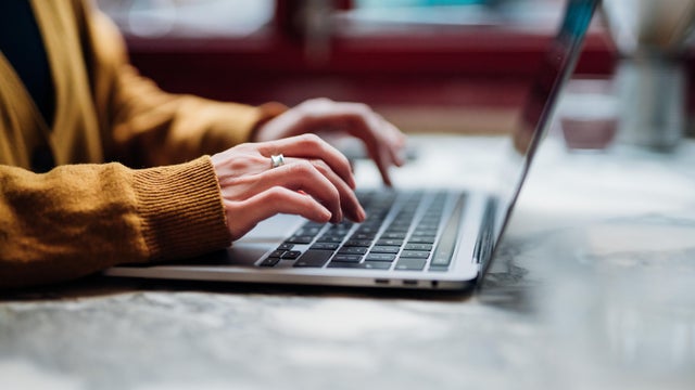 Closeup Shot Of An Unrecognizable Woman Using Laptop 