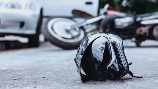 Black biker helmet on street 