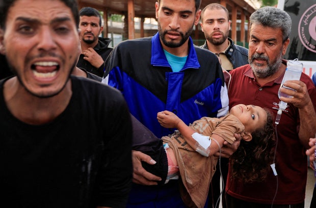 Palestinians inspect the damage at the European Hospital, in Khan Younis