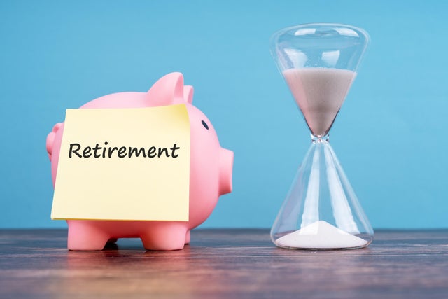 Retirement Text on Adhesive Note, Piggy Bank and Hourglass 