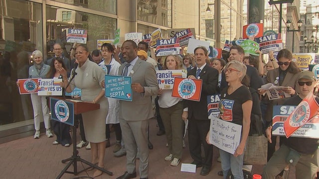 People gather with signs at a rally for SEPTA funding in Philadelphia. 