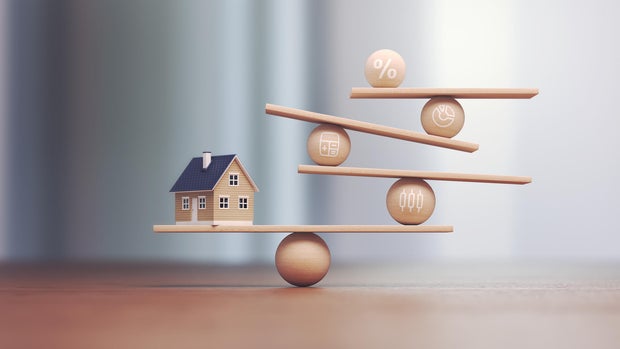 Real estate transactions and wooden balance scales, depth of field 