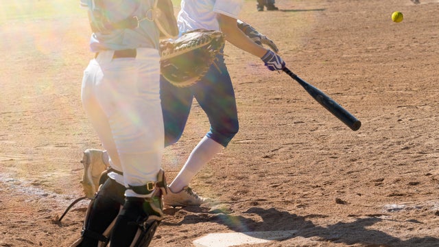Girl Getting a Hit  Playing Youth  Softball League Game 
