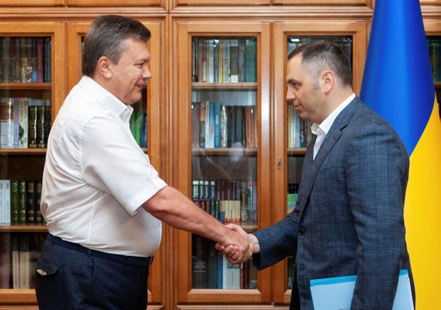 File Photo: Deputy Head of Ukrainian President Yanukovych and Management Portnov, shake his hands in Kiev 