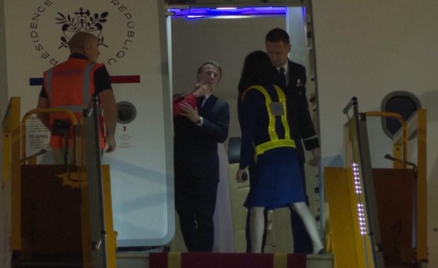 Emmanuel Macron's wife Brigitte Macron appears to shove his face upon arrival in Hanoi