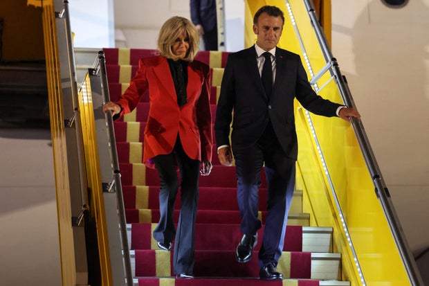 France's President Emmanuel Macron and his wife Brigitte Macron disembark from their plane upon arriving at Noi Bai International Airport in Hanoi, Vietnam