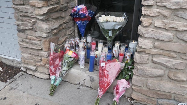 Flowers and candles on the front step of Bayonne Boxing. 