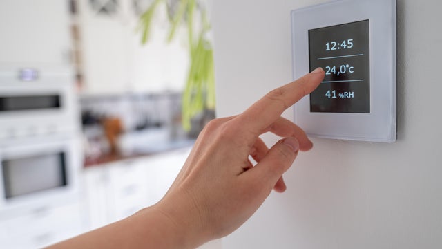 Hand using Air ventilation controller with display 