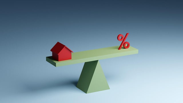 House and percentage sign on seesaw 