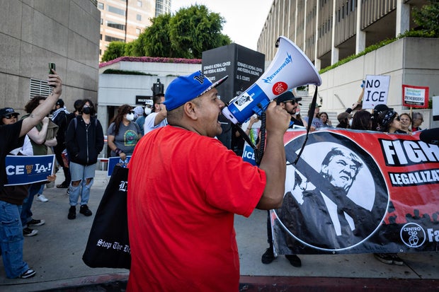 Demonstrators protest outside the Edward R. Roybal Federal Building and the Metropolitan Detention Center in response to ICE raids 