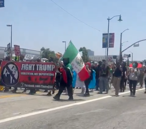 Protesters marching down a street in downtown Los Angeles on June 8. 