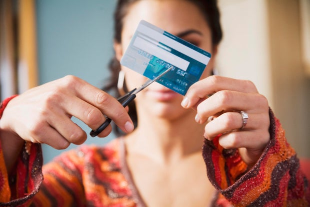 Woman cutting up credit card 