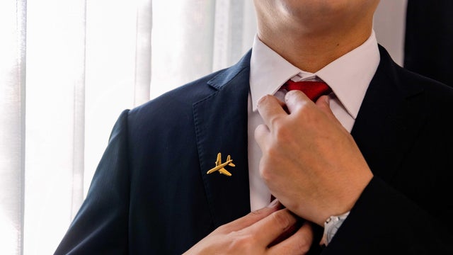 Cabin Crew getting dress for work, portrait. 