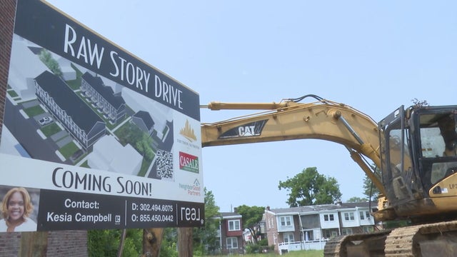 A sign for Raw Story Drive is seen near construction vehicles in Wilmington 