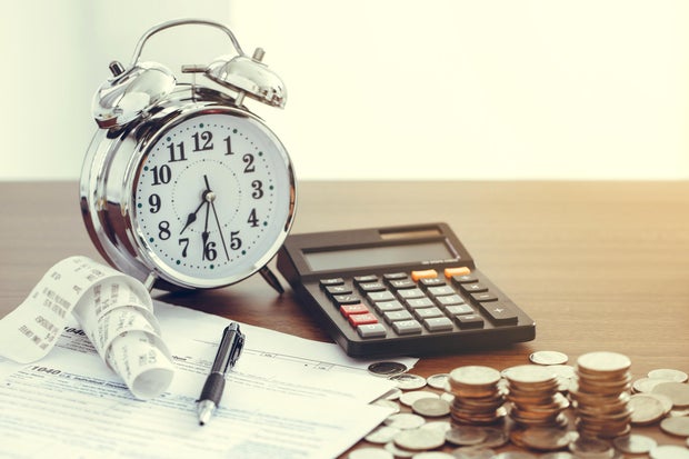 Tax-filling concept .Tax form 1040 with pen, clock,coins and calculator on desk.Tax concept 