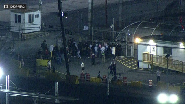 A small crowd of people gathered outside Delaney Hall in Newark, New Jersey, on June 12, 2025.