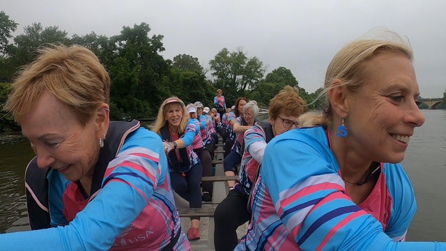A team of women paddle a dragon boat in the Schuylkill River near Philadelphia 