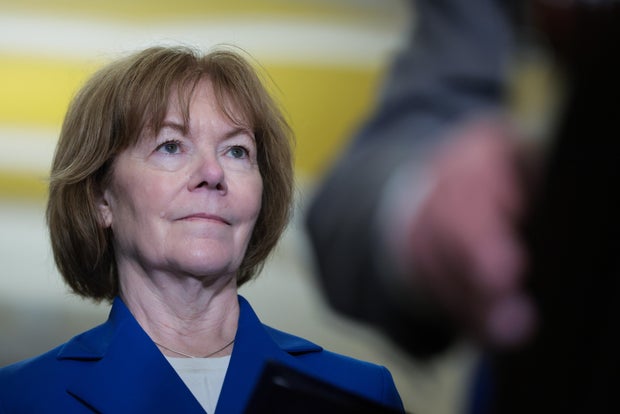 Sen. Tina Smith listens as Leader Chuck Schumer speaks to reporters following the weekly Democratic policy luncheon at the U.S. Capitol Building on June 10, 2025 in Washington, DC. 