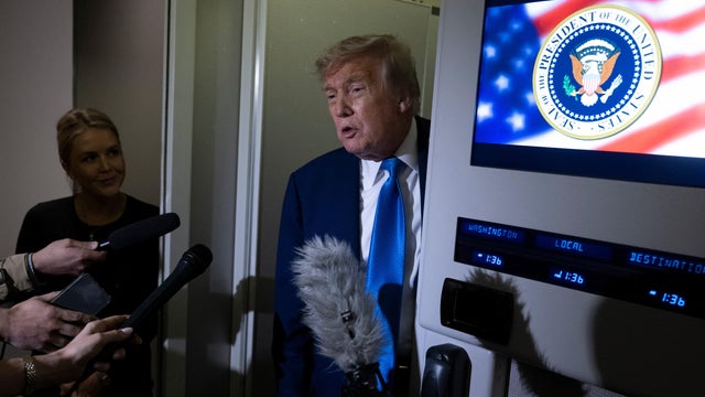 President Trump speaks to reporters aboard Air Force One 