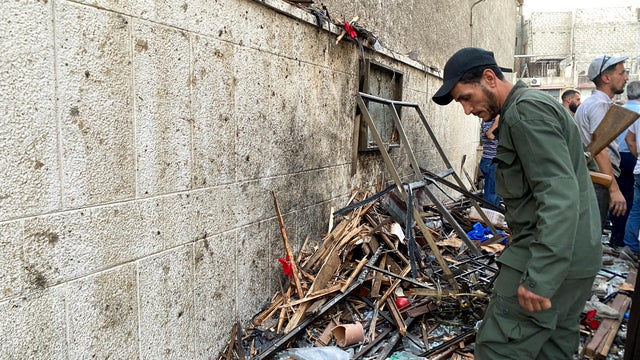 A member of the Syrian security force inspects the damage after a blast rocked the Mar Elias Church in the Dweila neighbourhood of Damascus 