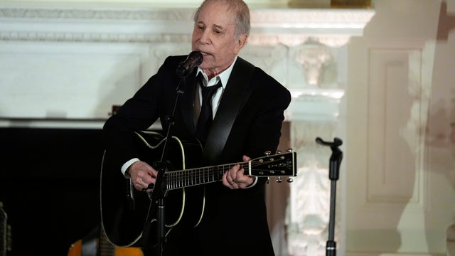 Paul Simon performs in the state dining room at the White House during the Biden administration 