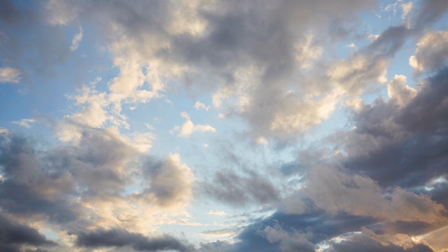 Full frame shot of blue sky and dark clouds, abstract background 