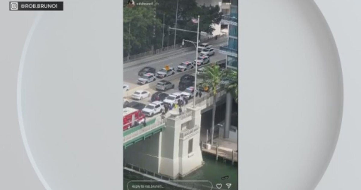 Woman hospitalized after crossing Brickell Avenue Bridge as it opened, Miami Police say; officer also injured