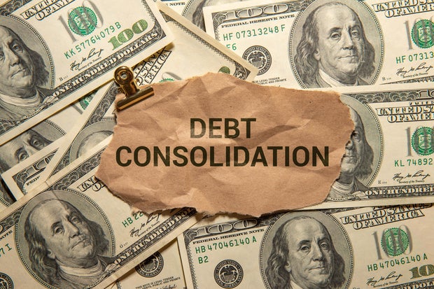 Business concept. DEBT CONSOLIDATION words in a white notebook 