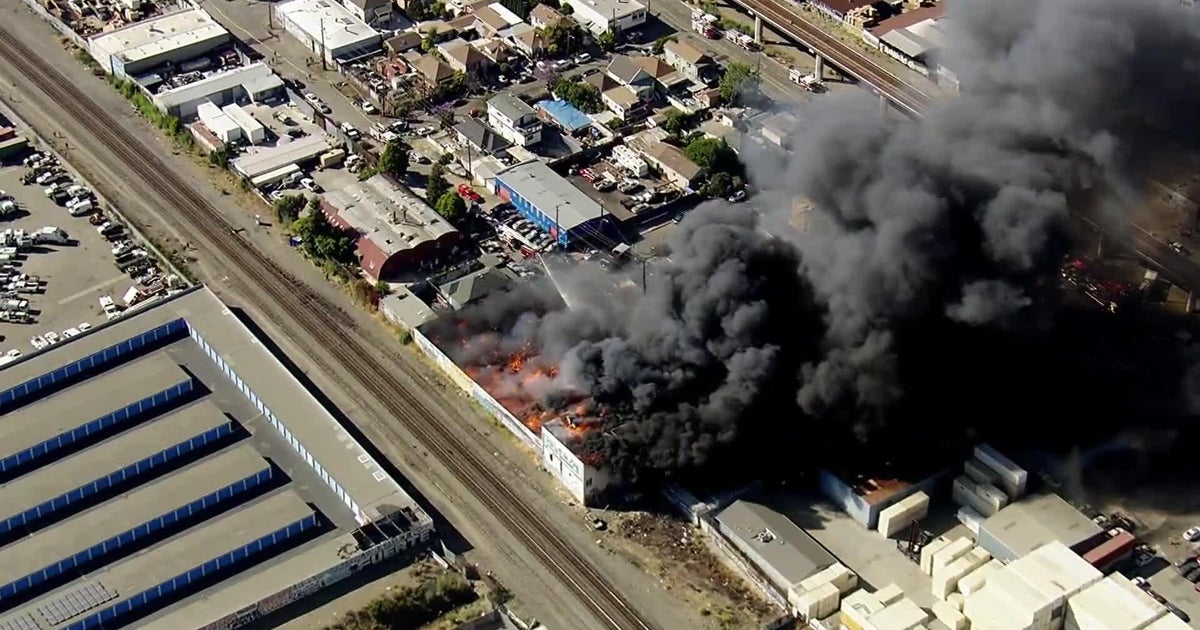 Watch: Huge fire destroys warehouse in Oakland - CBS San Francisco