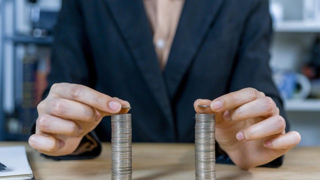Businessman stacking coins. 
