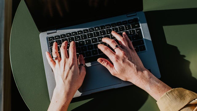 Close-up of hands typing on a laptop computer 