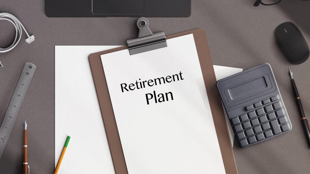 directy above workspace with laptop and office supplies.Retirement plan reminder 