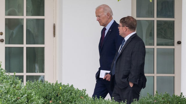Former President Joe Biden speaks with White House Physician Kevin O'Connor as he arrives back at the White House in Washington, DC, on August 28, 2023. 