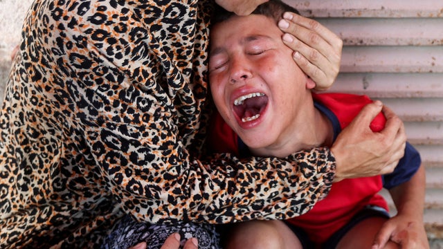 Palestinian casualties are carried into Al-Aqsa Martyrs Hospital in Deir al-Balah 
