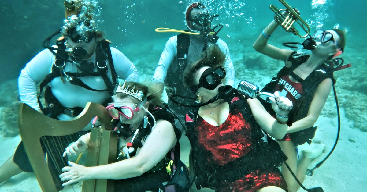 A concert played underwater? Watch mermaids, musicians and divers jam out all in the name of coral reef conservation