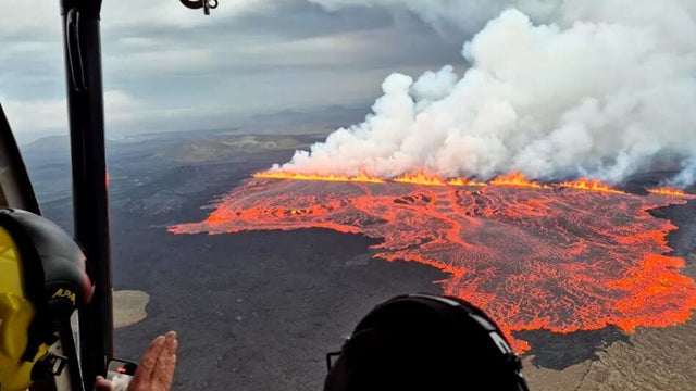 Lava emerges through a fissure following a volcano eruption near Grindavik 